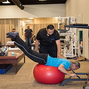 Hector Montano With Patient Using Exercise Ball