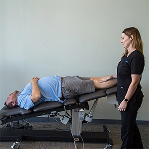 Staff Member With Patient In Decompression Machine