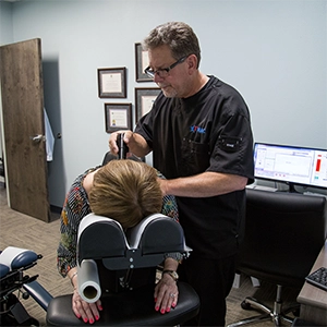 Chiropractor Stewart Chapman Adjusting A Patient
